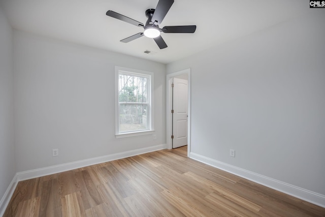 empty room with ceiling fan and light hardwood / wood-style floors