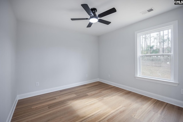 spare room featuring hardwood / wood-style floors and ceiling fan