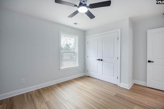 unfurnished bedroom featuring a closet, ceiling fan, and light wood-type flooring