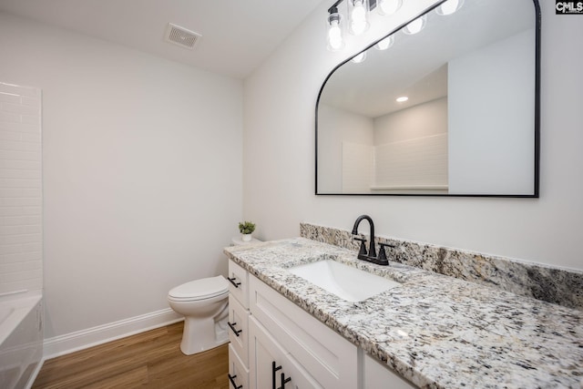 bathroom with wood-type flooring, toilet, and vanity