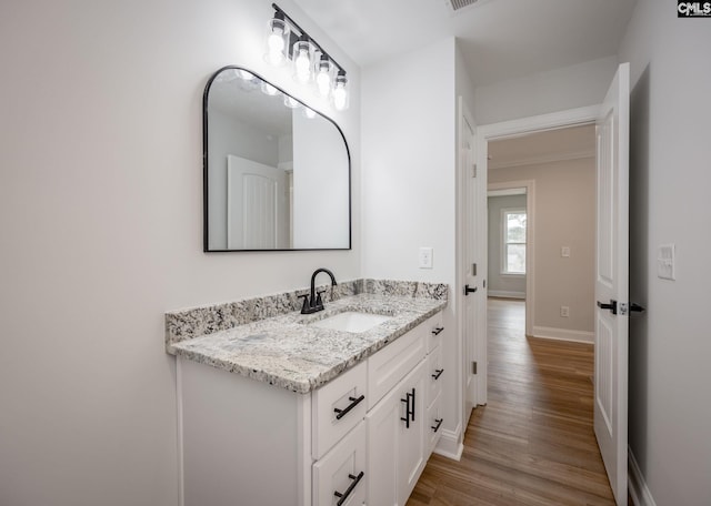 bathroom with vanity and hardwood / wood-style floors