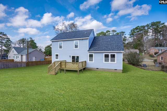 back of house featuring a wooden deck and a yard