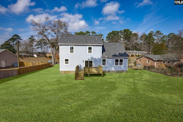 rear view of property with a deck and a lawn