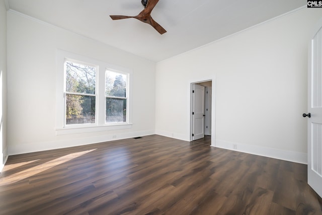 empty room featuring crown molding, dark wood-type flooring, and ceiling fan