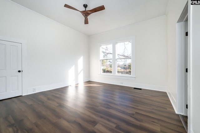 empty room featuring ceiling fan, ornamental molding, and dark hardwood / wood-style flooring