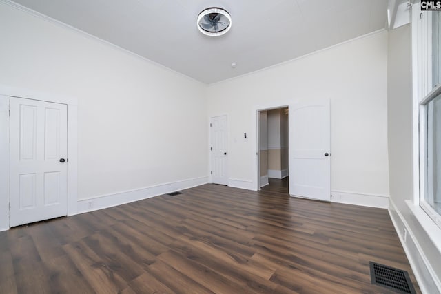 spare room featuring crown molding and dark hardwood / wood-style floors