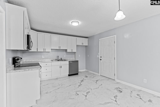 kitchen featuring pendant lighting, sink, white cabinets, stainless steel appliances, and a textured ceiling