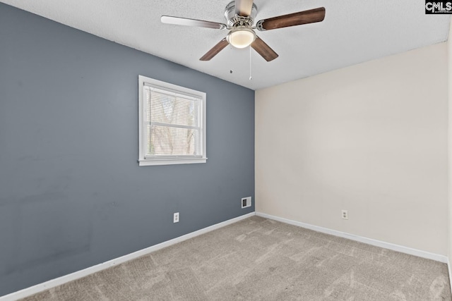 unfurnished room with ceiling fan, light carpet, and a textured ceiling