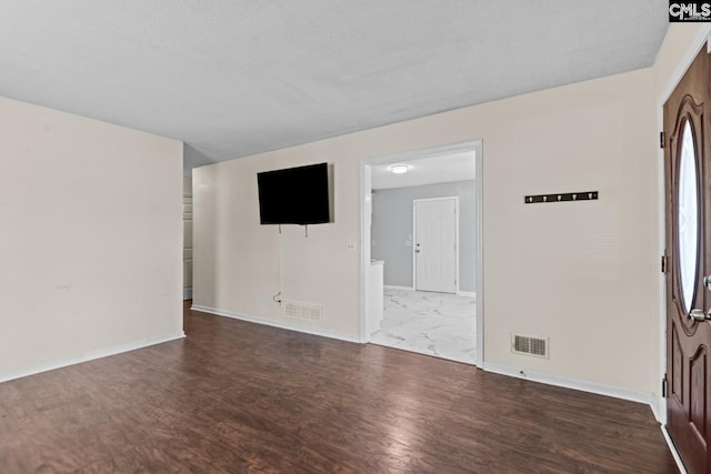 spare room featuring dark wood-type flooring