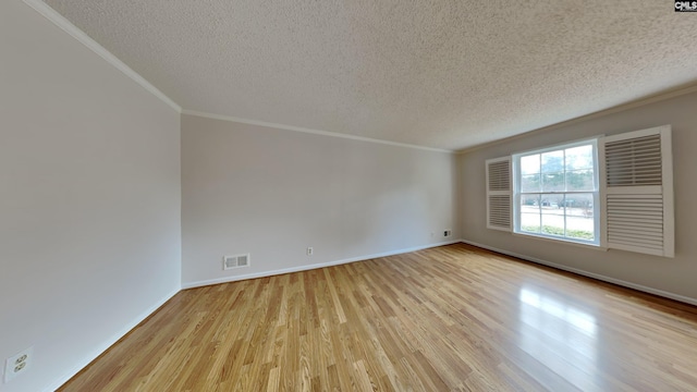 spare room with ornamental molding, light hardwood / wood-style flooring, and a textured ceiling