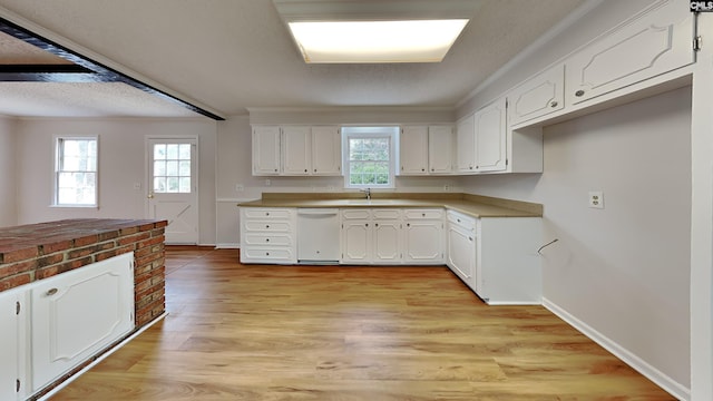 kitchen with sink, white cabinetry, a textured ceiling, white dishwasher, and light hardwood / wood-style floors