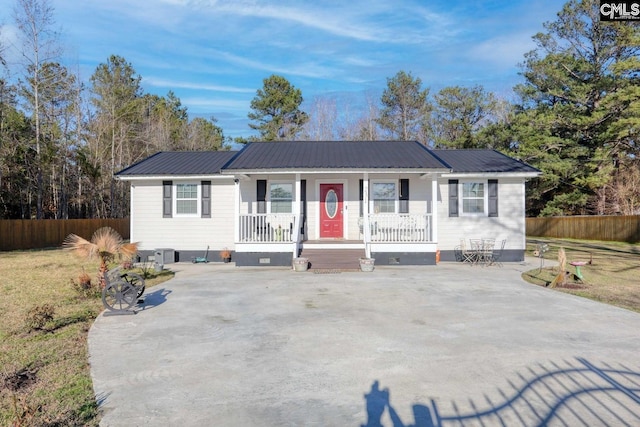 ranch-style house with a porch and cooling unit