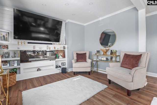 sitting room with crown molding and dark hardwood / wood-style floors