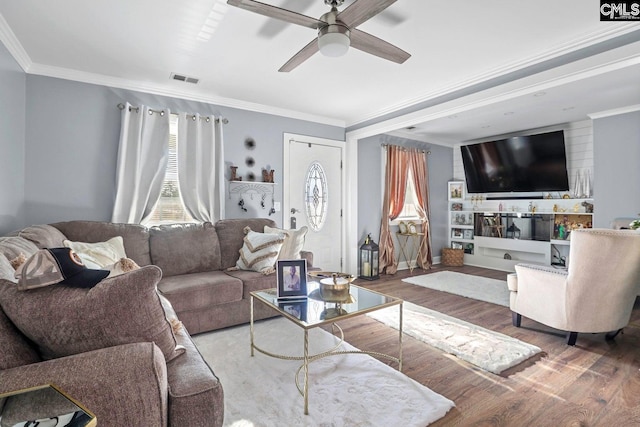 living room featuring ornamental molding, hardwood / wood-style floors, and ceiling fan