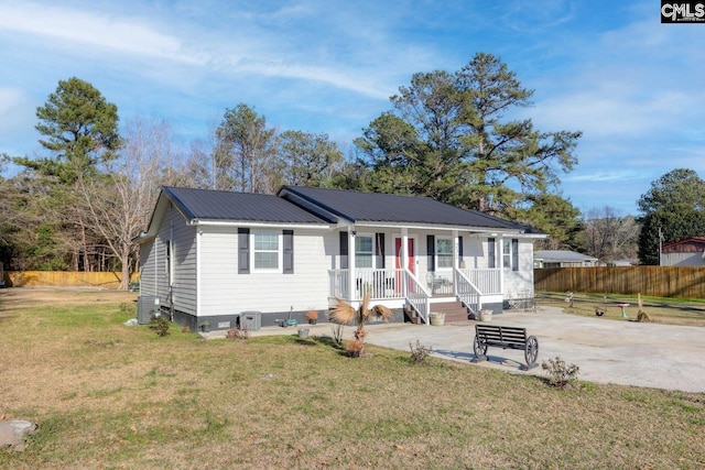 view of front of home with a porch, a patio, and a front yard