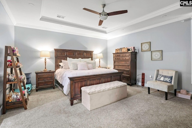 carpeted bedroom featuring a raised ceiling, crown molding, and ceiling fan