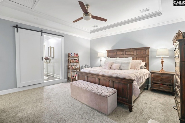 bedroom featuring light carpet, ornamental molding, a raised ceiling, ceiling fan, and a barn door