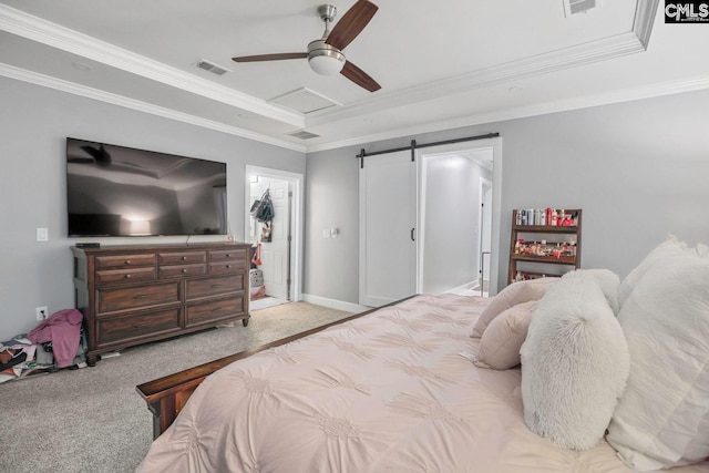 bedroom with a raised ceiling, ornamental molding, a barn door, and light carpet