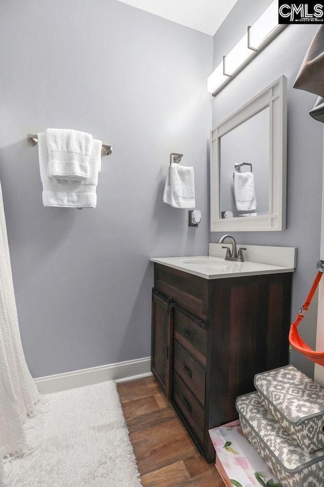 bathroom with hardwood / wood-style flooring and vanity