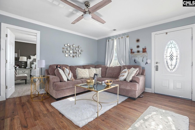 living room featuring crown molding, ceiling fan, and dark hardwood / wood-style flooring