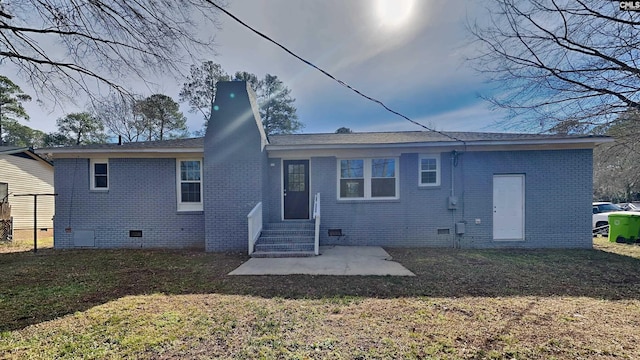 back of property featuring a patio area and a lawn