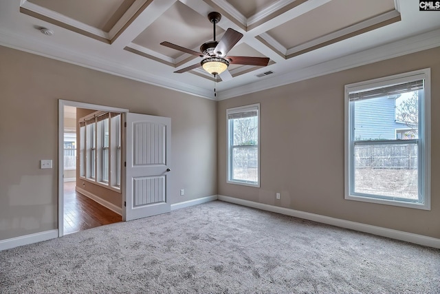 carpeted spare room with beam ceiling, ornamental molding, coffered ceiling, and ceiling fan