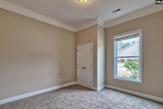 spare room with light colored carpet, a healthy amount of sunlight, and ornamental molding