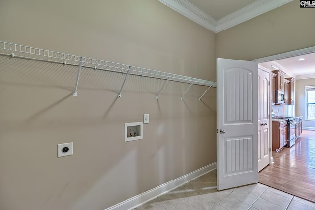 laundry room featuring crown molding, light tile patterned floors, hookup for a washing machine, and hookup for an electric dryer