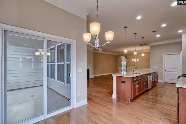 kitchen featuring sink, light stone counters, crown molding, hanging light fixtures, and stainless steel dishwasher