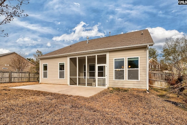 rear view of house featuring a sunroom and a patio