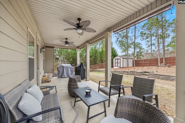 view of patio with area for grilling, an outdoor hangout area, ceiling fan, and a storage shed