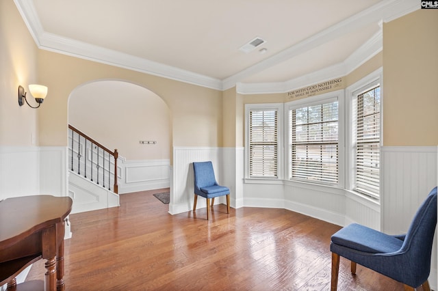 sitting room with crown molding and hardwood / wood-style floors