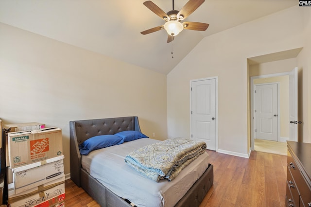 bedroom featuring lofted ceiling, ceiling fan, and light wood-type flooring