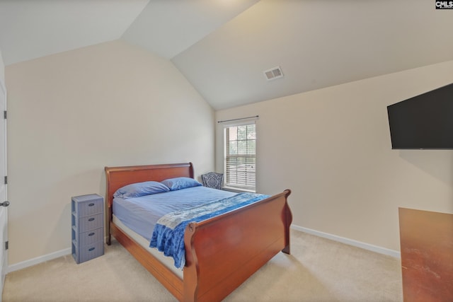 carpeted bedroom with lofted ceiling