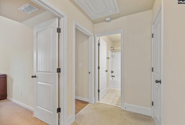 hallway with light colored carpet