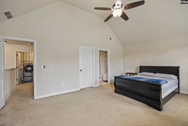 bedroom featuring connected bathroom, high vaulted ceiling, washer / clothes dryer, light colored carpet, and ceiling fan