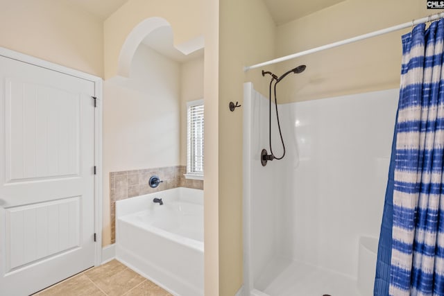 bathroom with tile patterned floors and independent shower and bath