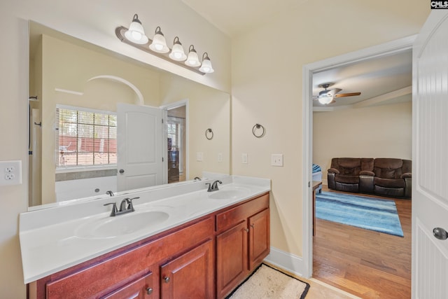 bathroom with hardwood / wood-style flooring, vanity, and ceiling fan