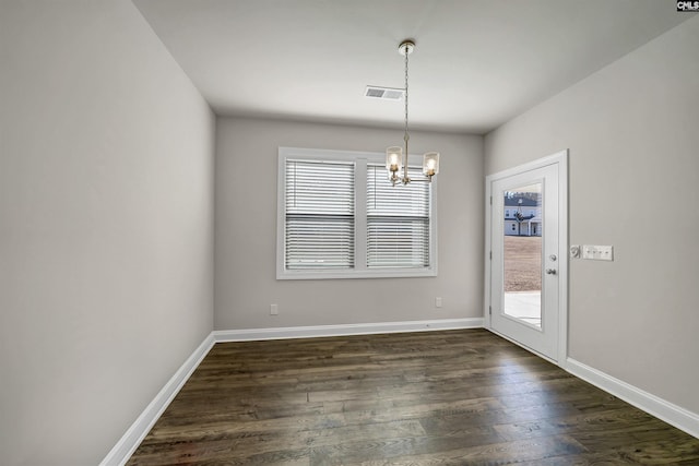 interior space featuring dark wood-type flooring and a notable chandelier