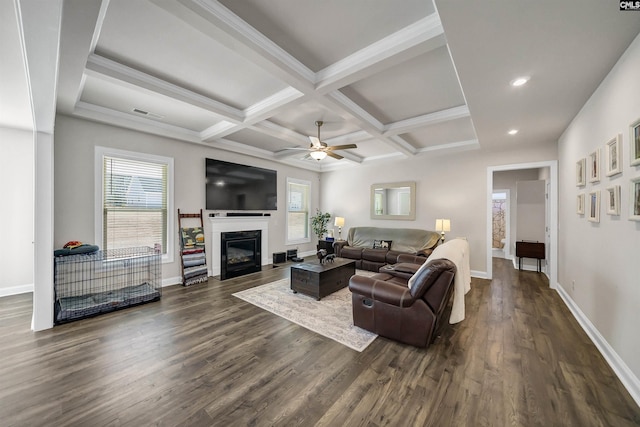 living room with coffered ceiling, a healthy amount of sunlight, and dark hardwood / wood-style floors