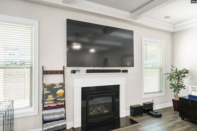 living room featuring hardwood / wood-style floors, beam ceiling, and ornamental molding