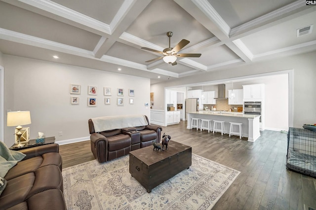 living room with coffered ceiling, hardwood / wood-style floors, and beamed ceiling