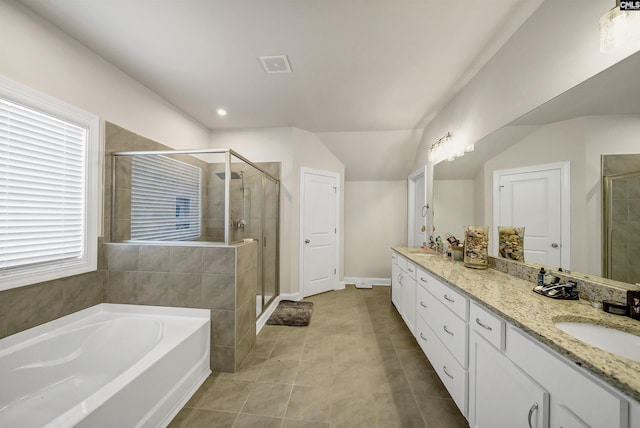 bathroom featuring tile patterned floors, vanity, separate shower and tub, and lofted ceiling