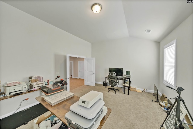 carpeted office space with vaulted ceiling