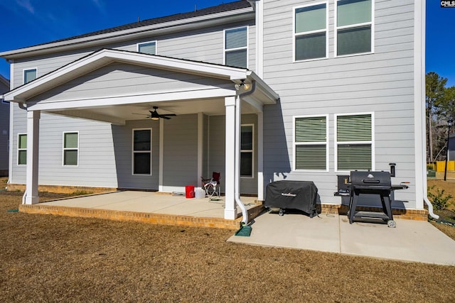 rear view of property featuring a yard, a patio, and ceiling fan