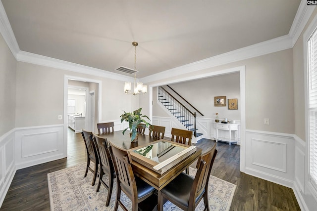 dining area featuring a notable chandelier, crown molding, and dark hardwood / wood-style floors