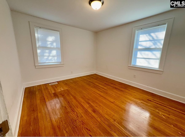 empty room with hardwood / wood-style flooring