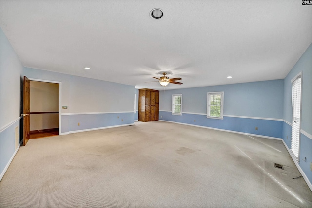 unfurnished room with ceiling fan and light carpet