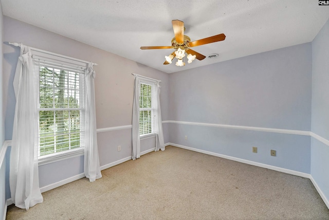 unfurnished room with ceiling fan and light carpet