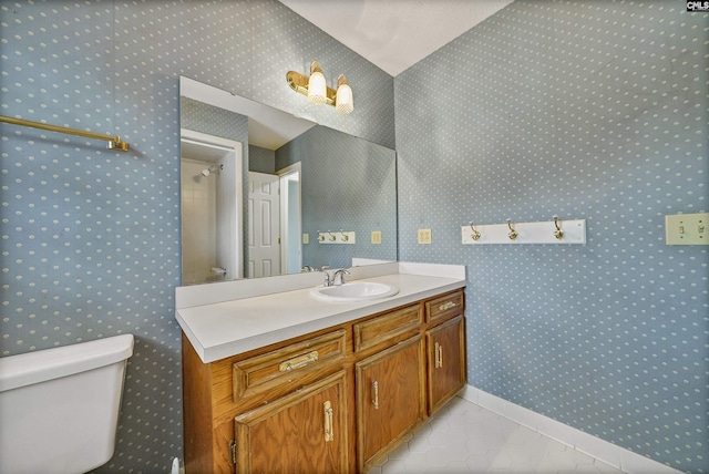 bathroom with vanity, walk in shower, tile patterned floors, and toilet